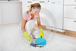 Woman Sweeping Floor With Broom And Dustpan