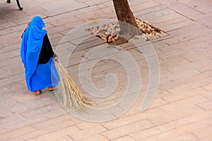 Woman sweeping Jaleb Chowk - main courtyard of Amber Fort, Rajasthan, India