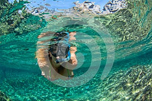 Woman swim with snorkel at Los Gigantes beach in Tenerife Canary Islands