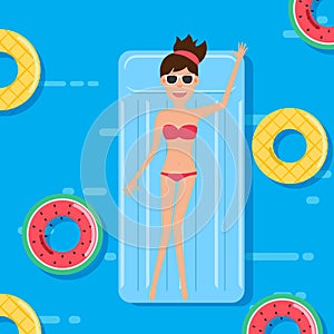 Woman in swim suit lying on floating swimming pool mattress with fruits rubber ring. Summer vacation