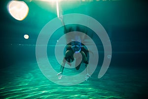 Woman swim underwater pool with snorkel