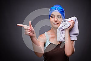 The woman swimmer against grey background