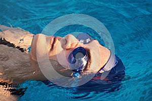 Woman swimmer in blue glasses