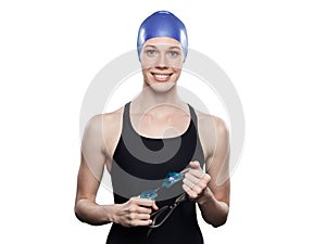 Woman swimmer isolated over white background. Sportswoman smiling. Sportswoman wearing swimming cap holds goggles in hands