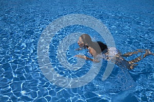 Woman swimming breaststroke in a pool