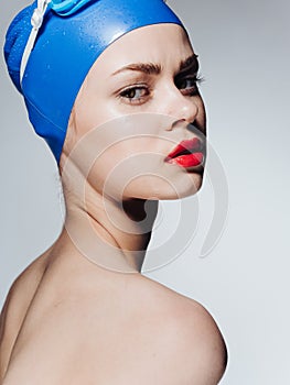 Woman in swimming cap with red lips makeup model naked shoulders