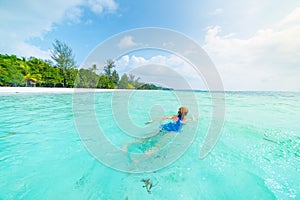 Woman swimming in caribbean sea turquoise transparent water. Tropical beach in the Kei Islands Moluccas, summer tourist