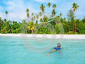 Woman swimming in caribbean sea turquoise transparent water. Tropical beach in the Kei Islands Moluccas, summer tourist