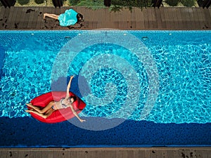 Woman is swimming on an inflatable lounger