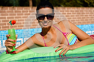 woman in swimming pool in bikini smiling