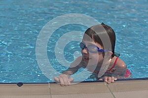 Woman in a swimming pool. Girl in a swimsuit swims in the pool