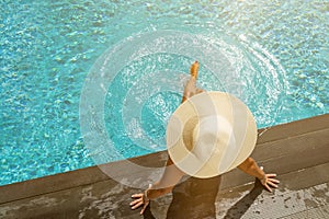 Woman at the swimming pool on the island of Santorini in Greece