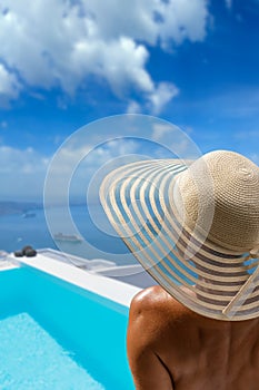 Woman at the swimming pool on the island of Santorini in Greece