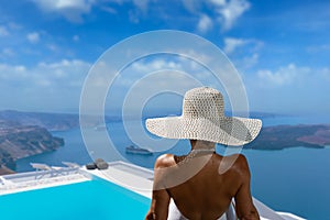 Woman at the swimming pool on the island of Santorini in Greece