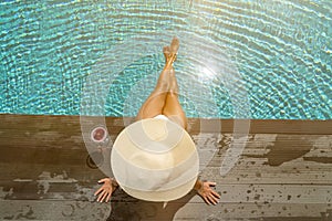 Woman at the swimming pool on the island of Santorini in Greece