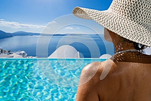 Woman at the swimming pool on the island of Santorini in Greece