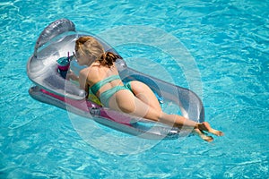 Woman in swimmsuit on inflatable mattress. Summer vacation. Girl swimming pool. Summer lady.