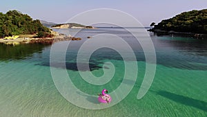 A woman swims in the sea, top view.