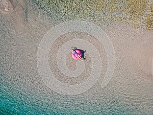 A woman swims in the sea, top view.