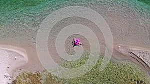 A woman swims in the sea, top view.