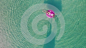 A woman swims in the sea, top view.