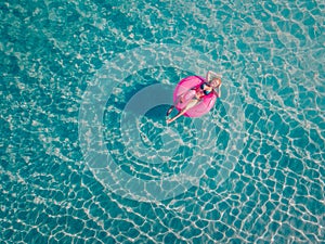 A woman swims in the sea, top view.