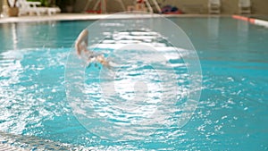 Woman swims underwater in the pool