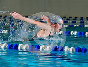 Woman swims using the butterfly stroke