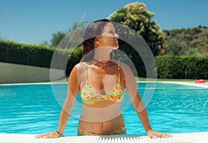 Woman in swimsuit leaving the pool