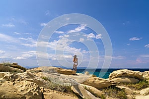 Woman in swimsuit looking out to the sea