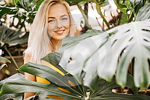 Woman in swimsuit on tropical plants background