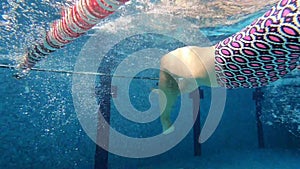 woman in swimsuit underwater at public pool