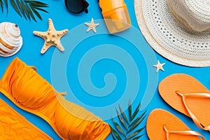 Woman swimwear and beach accessories flat lay top view on colored background Summer travel concept. bikini swimsuit, straw hat and