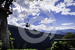 Woman on the swing of the end of the world Columpio del fin del mundo in BaÃÂ±os, Ambato. photo