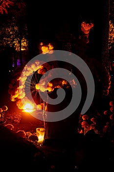 woman on a swing at night with warm lights in the background,