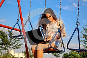 Woman on swing with notebook