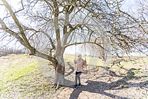 Woman on a swing in a park.