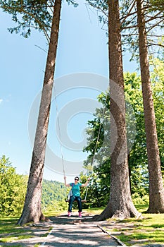 Woman swing between the trees