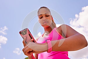 Woman Syncronizing Fitness Watch Fitwatch With Phone