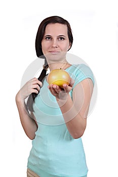 The woman in a t-shirt holds apple in hand