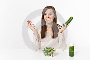 Woman at table with green detox smoothies, fresh salad in glass bowl, tomato, cucumber isolated on white background