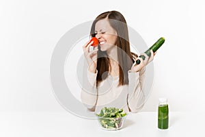 Woman at table with green detox smoothies, fresh salad in glass bowl, tomato, cucumber isolated on white background