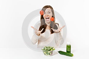 Woman at table with green detox smoothies, fresh salad in glass bowl, tomato, cucumber isolated on white background