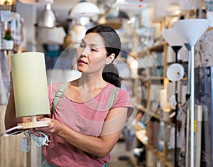 Woman with table lamp in store photo