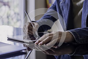 Business woman hand using electronic or stylus pen, work on digital tablet