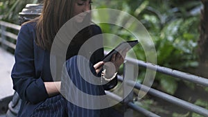 Woman with a tablet computer in Botanical Garden in Atocha Train Station, Madrid