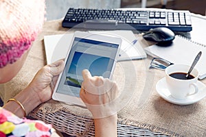 Woman and tablet computer in hand sliding on touching screen use