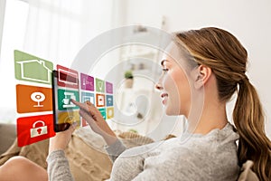 Woman with tablet computer and smart home icons