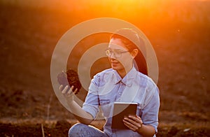 Woman with tablet and earth clod