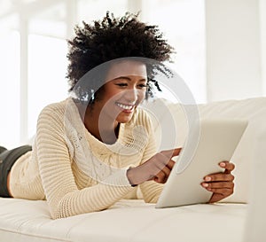 Woman, tablet and happy in home on sofa, social media and typing or browse for online shopping or networking photo